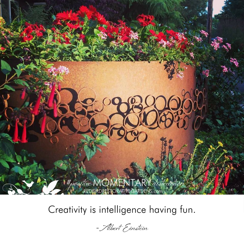 Planter with red flowers Albert Einstein quote